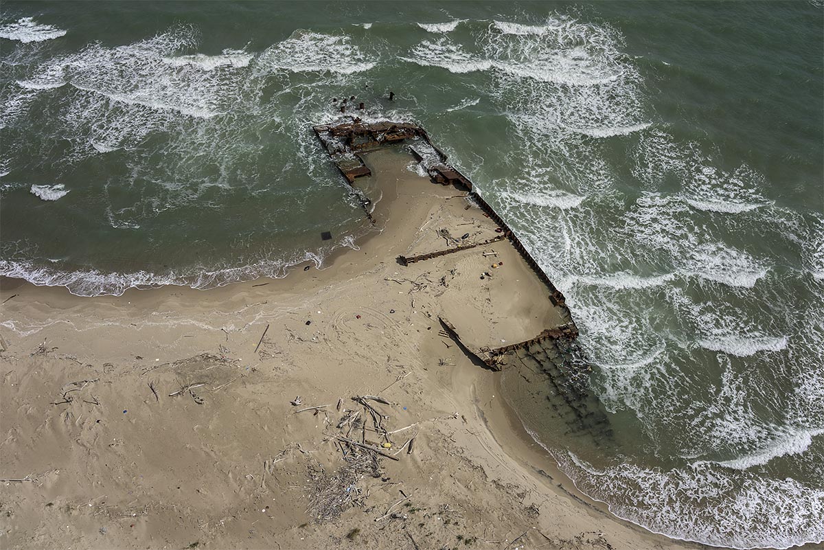 stranded #25, italy, 2015 (the 'eden 5' dropped 123 radioactive barrels at this national park beach. fake papers, no crew. the gov. never removed the ship so the easy parts were scrapped)